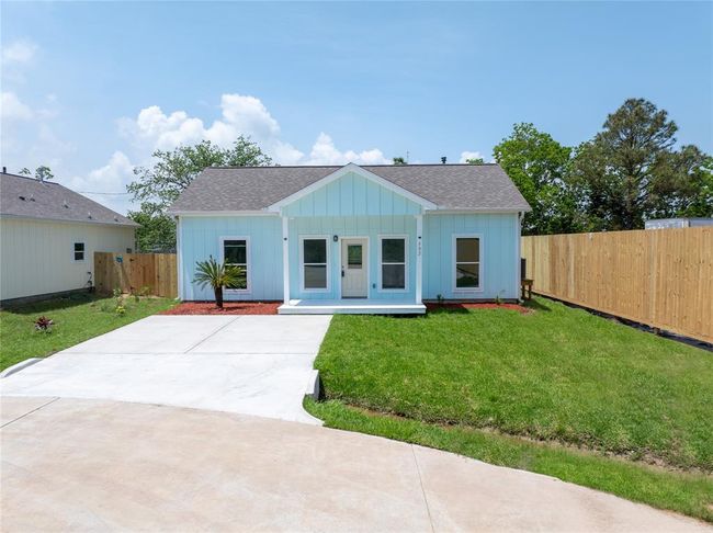 Charming single-story light blue house with a welcoming front porch. Features a neatly manicured lawn, white driveway, and fenced backyard. Ideal for comfortable living. | Image 21