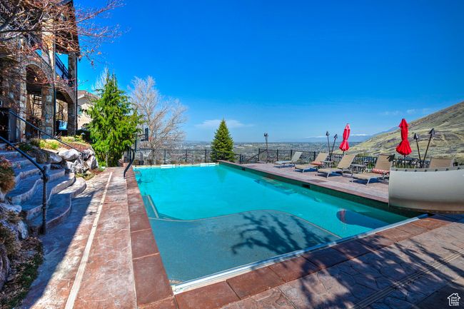Pool featuring a patio area and fence | Image 63