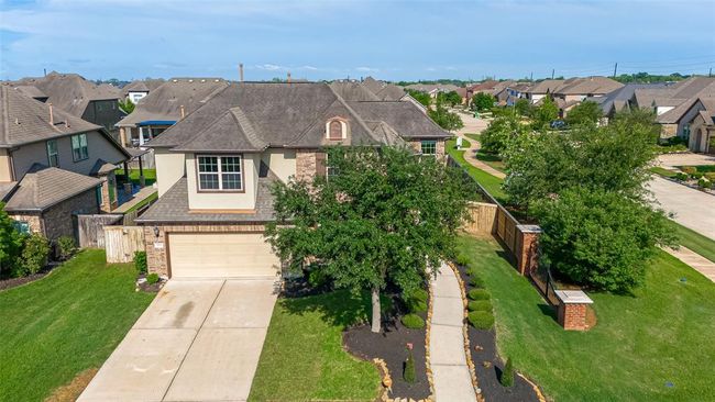 The house is in a suburban neighborhood with similar style homes and features a fenced backyard. | Image 44