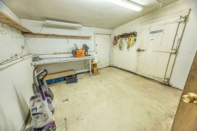 Basement with a workshop area | Image 43