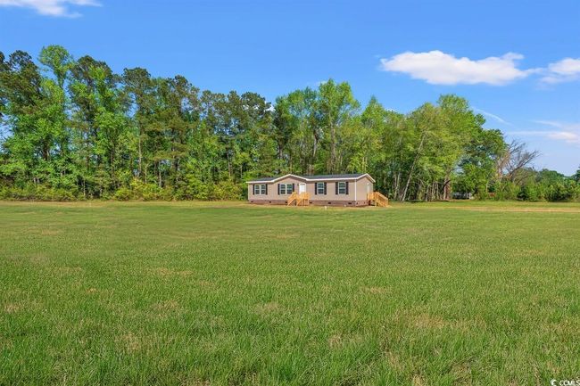 View of green lawn featuring a view of trees | Image 29