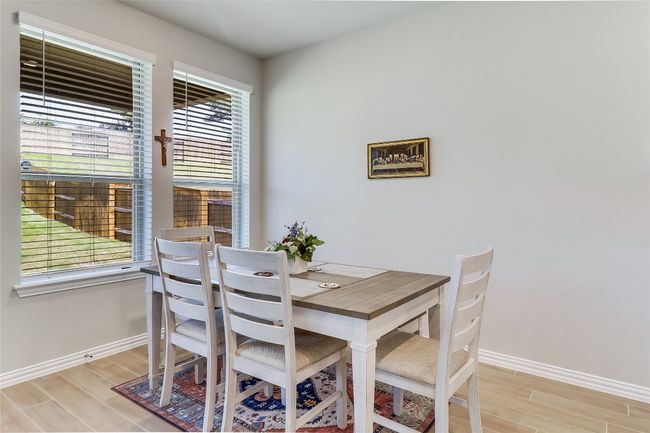 Dining room with baseboards and light wood-type flooring | Image 16