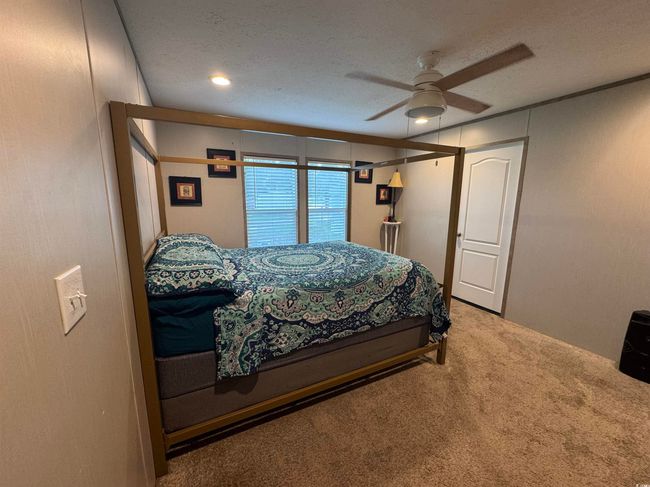 Carpeted bedroom featuring ceiling fan | Image 11