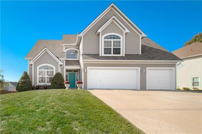 View of front of home with a front lawn and 3 car garage | Image 1