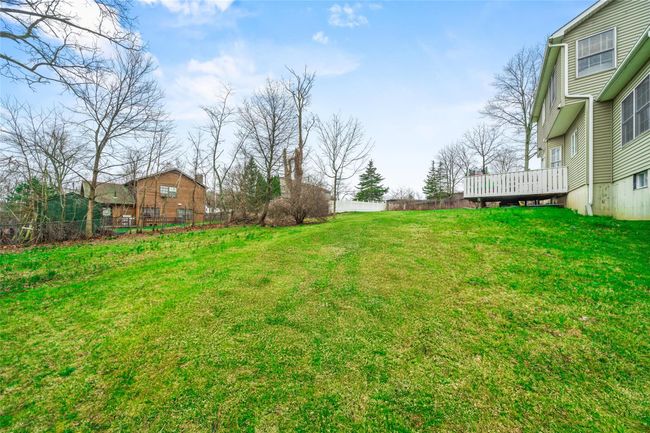 View of yard featuring fence and a wooden deck | Image 48