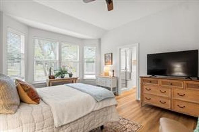 Bedroom with wood finished floors and ceiling fan | Image 7