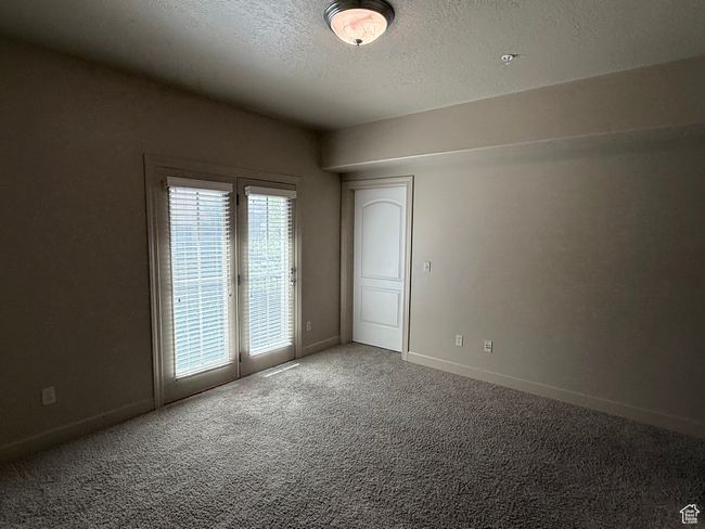 Empty room featuring carpet, a textured ceiling, and baseboards | Image 13