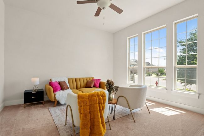 Living area featuring a ceiling fan, baseboards, and carpet floors | Image 5