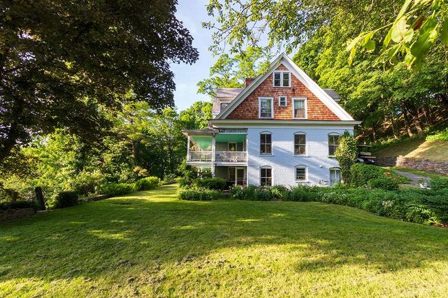 Back of house with a yard and a balcony | Image 17