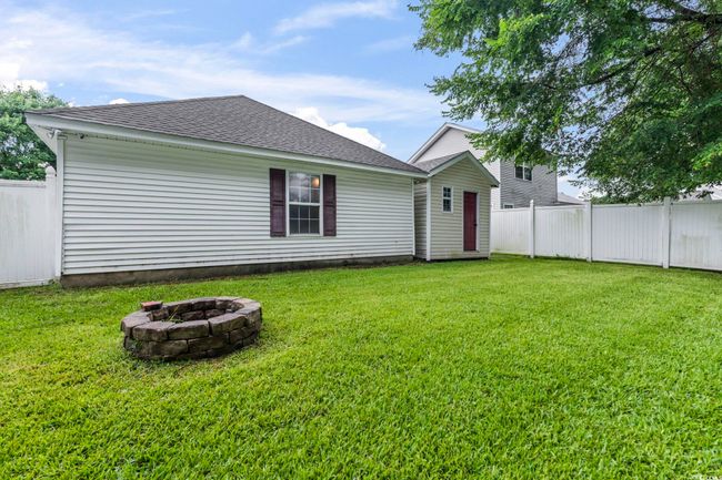 Back of property with a fire pit and roof with shingles | Image 28