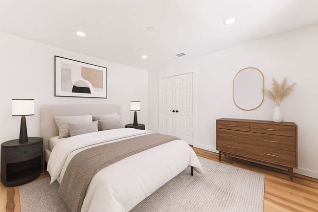 Bedroom with light wood finished floors, recessed lighting, and a closet | Image 24