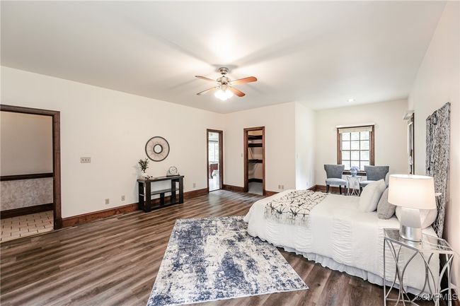 Bedroom with dark wood finished floors, baseboards, and ceiling fan | Image 19