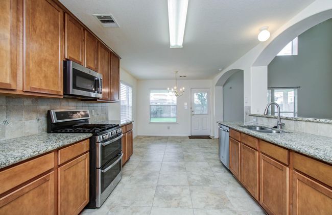 This well appointed kitchen has recently updated appliances, excellent storage, and great natural light. | Image 9