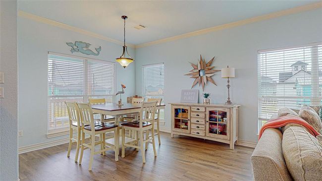 Off the family room, you'll find the dining room, a bright and airy space surrounded by windows that let in an abundance of natural light. It's truly one of the best rooms in the house, offering a perfect setting for meals gatherings, and late night game nights while enjoying scenic views! | Image 14