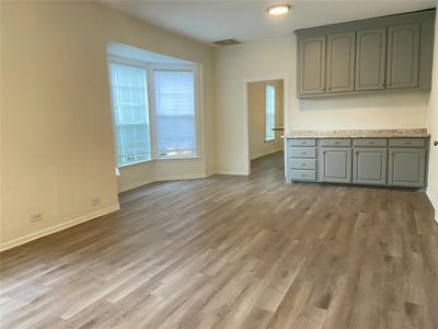 Unfurnished living room with wood-type flooring | Image 3