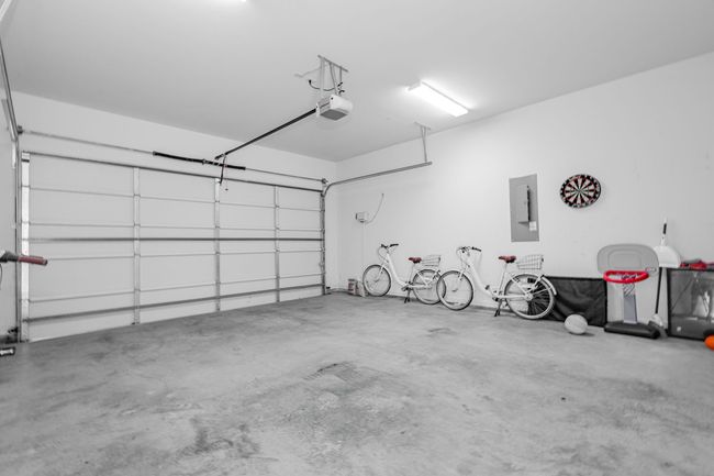 Garage with a garage door opener and electric panel | Image 37