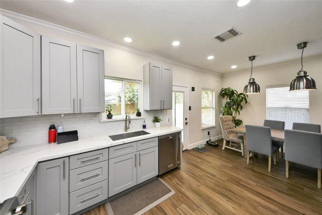 Enjoy an updated kitchen featuring elegant quartz countertops and stylish, modern cabinetry. | Image 11