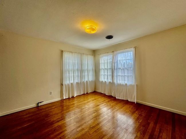 Unfurnished room featuring wood finished floors and baseboards | Image 17