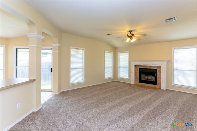 Living room showing more windows and a ceiling fan. | Image 18