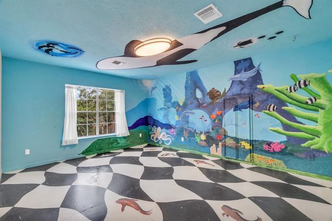 This secondary bedroom features a hand painted aquarium mural covering most of the room from ceiling to floor! | Image 22