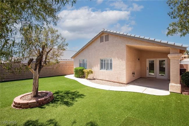 Back of property featuring fence, french doors, stucco siding, and a yard | Image 32