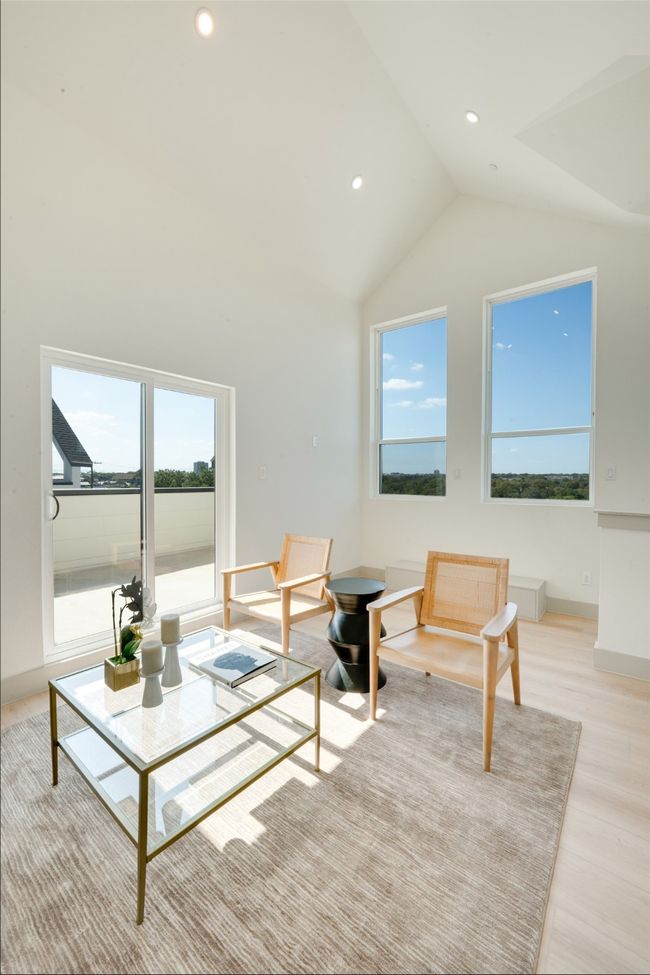 Living room featuring a wealth of natural light, high vaulted ceiling, and light wood-type flooring | Image 31