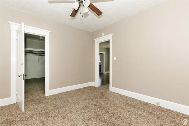 Interior space featuring concrete floors, a textured ceiling, visible vents, and baseboards | Image 18