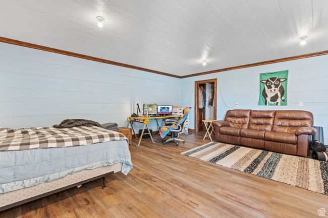 Bedroom featuring hardwood / wood-style flooring and a spacious closet | Image 52