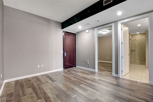 Den featuring recessed lighting, wood finished floors, visible vents, and baseboards | Image 15
