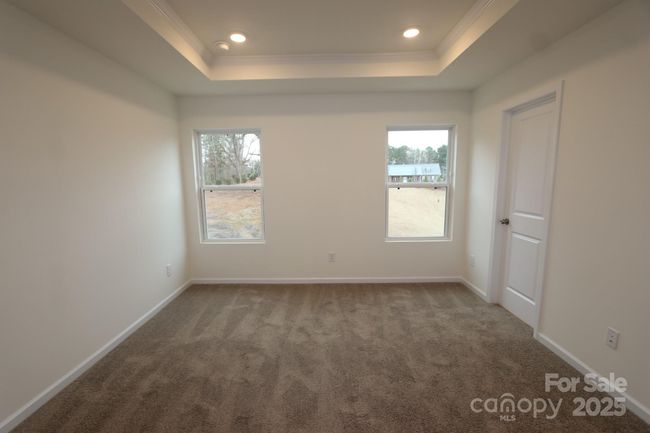 Primary bedroom with tray ceilings | Image 17