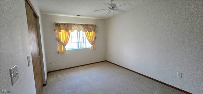 Carpeted empty room featuring ceiling fan and baseboards | Image 17