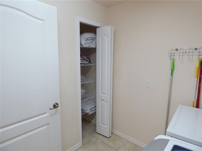 laundry room with washer and dryer, linen closet opening on the guest hallway | Image 56