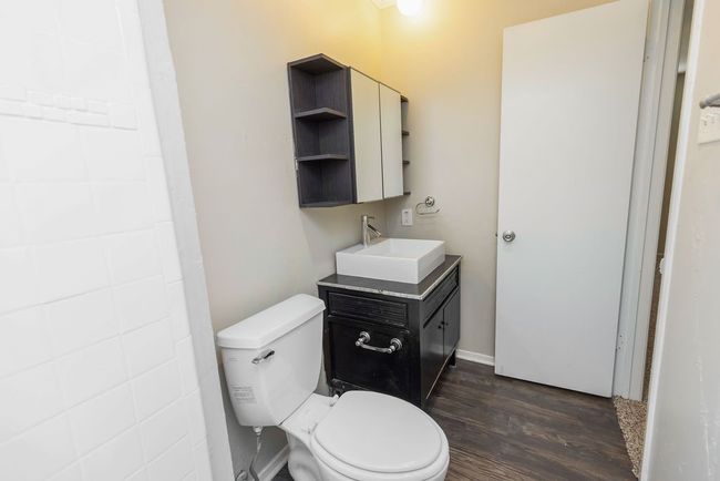 Bathroom featuring toilet, vanity, and wood finished floors | Image 26