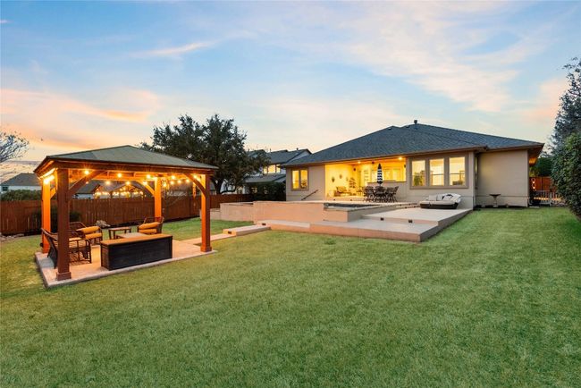 Backyard Oasis with Sparkling Pool, Pergola, and Outdoor Kitchen | Image 32