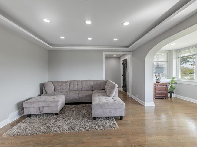Sun-drenched living room with gleaming hardwood fl | Image 13