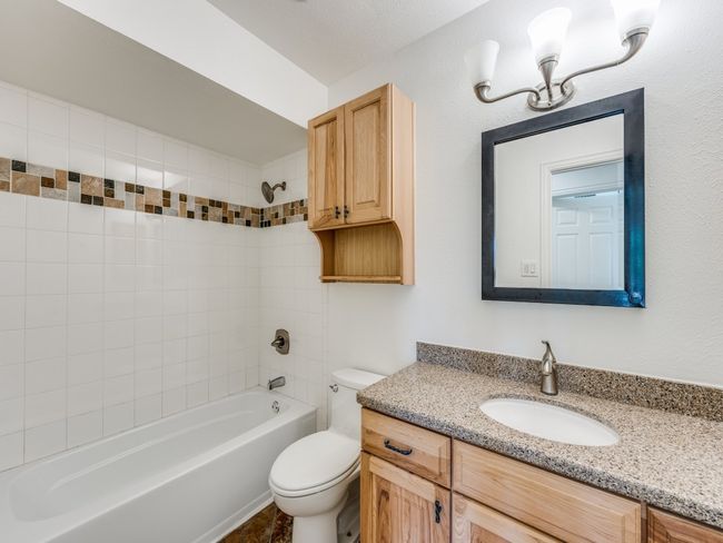 Full bathroom featuring vanity and shower / bath combination | Image 16