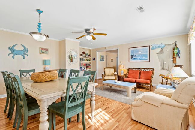 Dining space with built in shelves, hardwood / wood-style floors, ceiling fan, and ornamental molding | Image 4