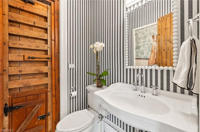 Half bath featuring wallpapered walls, toilet, and a sink | Image 18
