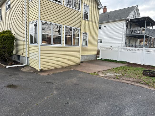 Back view of the unit showing patio and additional parking | Image 16