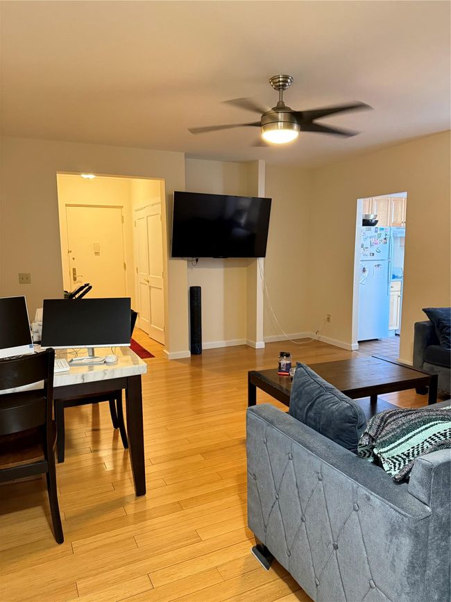 Living room featuring ceiling fan, light wood-type flooring, and baseboards | Image 4