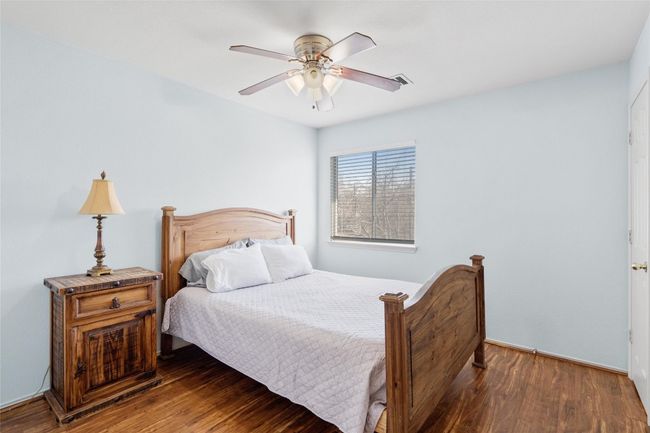Bedroom with wood finished floors and a ceiling fan | Image 25