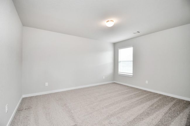 Generously sized secondary bedrooms featuring spacious closets, soft and inviting carpeting underfoot, large windows allowing plenty of natural light, and the added touch of privacy blinds for your personal retreat. | Image 36