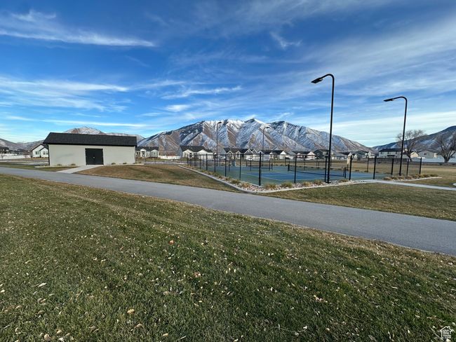 Surrounding community featuring a mountain view, a tennis court, fence, and a lawn | Image 6