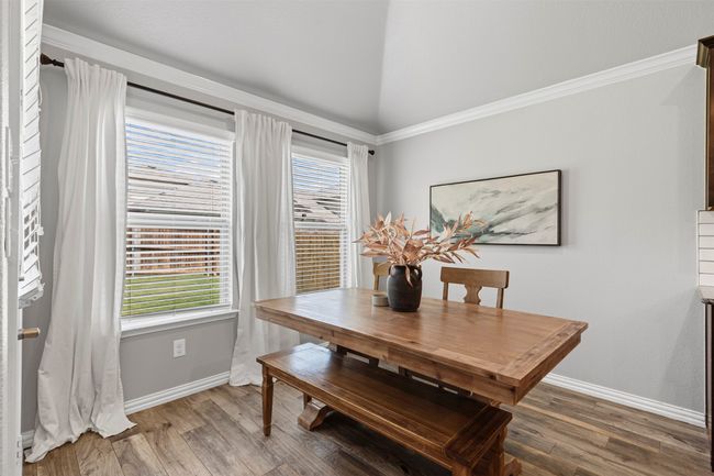 Eat in kitchen area featuring vaulted ceiling and wood finished floors | Image 20