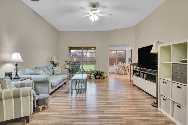 Living room featuring ceiling fan and light wood-type flooring | Image 6