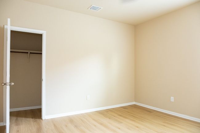 Unfurnished bedroom featuring light wood-style floors, baseboards, a closet, and a spacious closet | Image 17