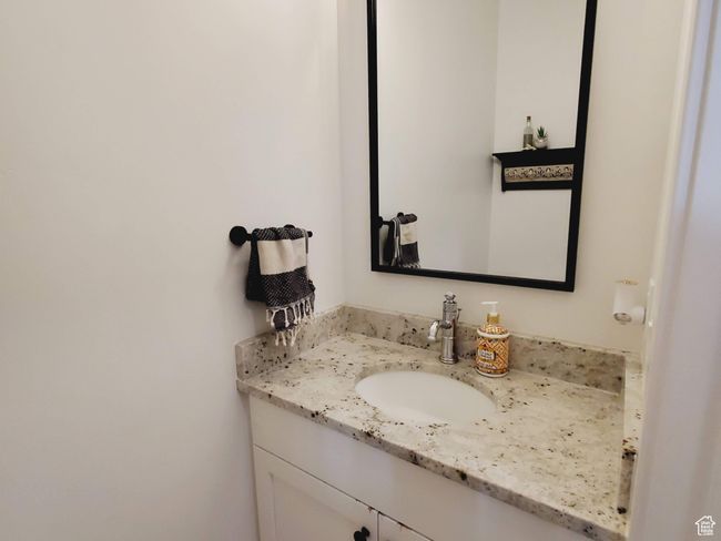 Bathroom featuring baseboards, wood finished floors, and vanity | Image 9