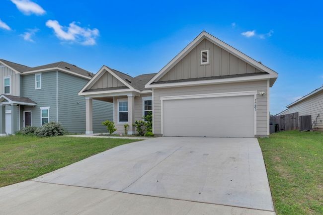 Located in a desirable neighborhood, the front of the home exudes warmth and character. | Image 9