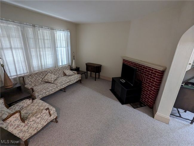 First-Floor Living room with a brick fireplace and light colored carpet | Image 4