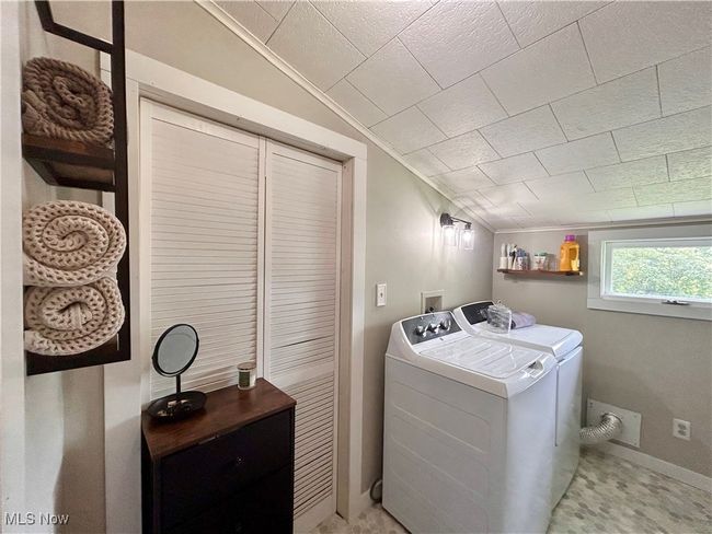 Washroom featuring washing machine and clothes dryer | Image 9